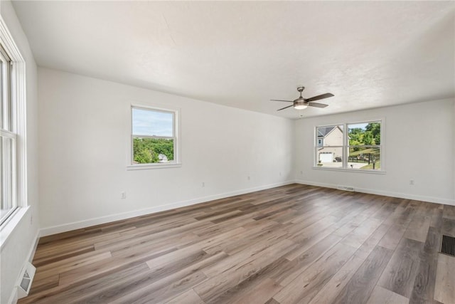 1621 Windsor Rd, North Huntingdon, PA 15642 - spare room featuring healthy amount of natural light, wood finished floors, a ceiling fan, and baseboards