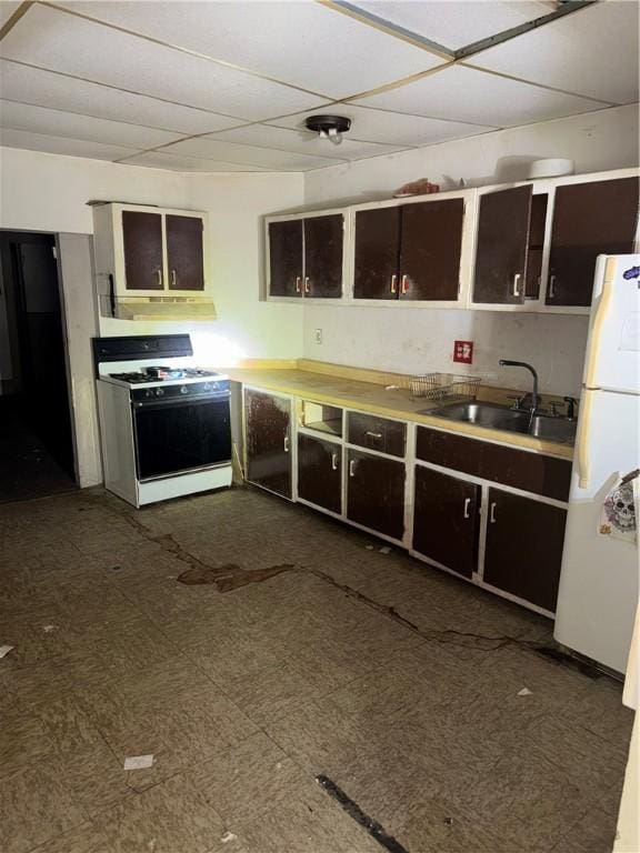 kitchen with white appliances, a sink, dark brown cabinetry, and light countertops
