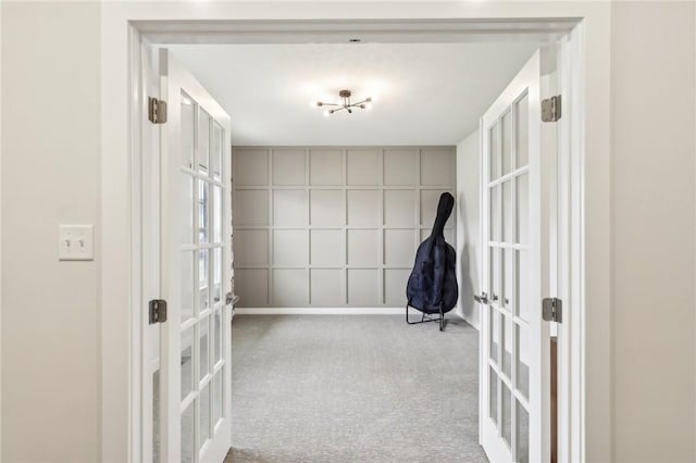 hall with french doors and carpet flooring