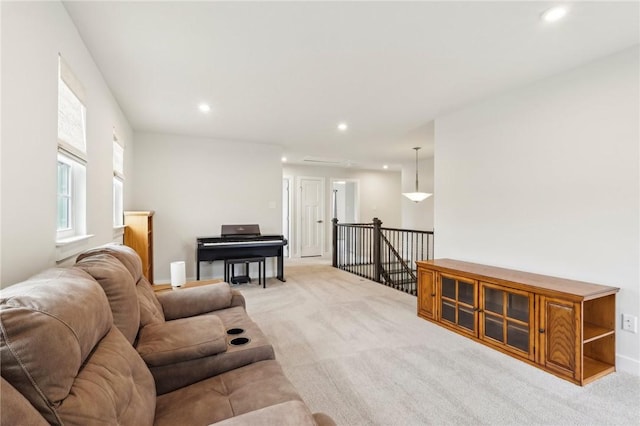 living area featuring light colored carpet and recessed lighting