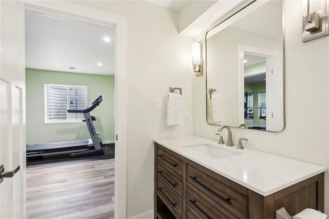 bathroom with wood finished floors, vanity, and recessed lighting