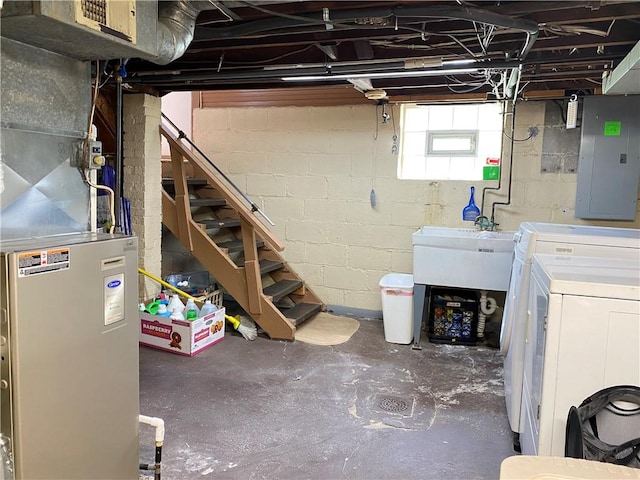 below grade area with electric panel, stairs, washing machine and dryer, and a sink