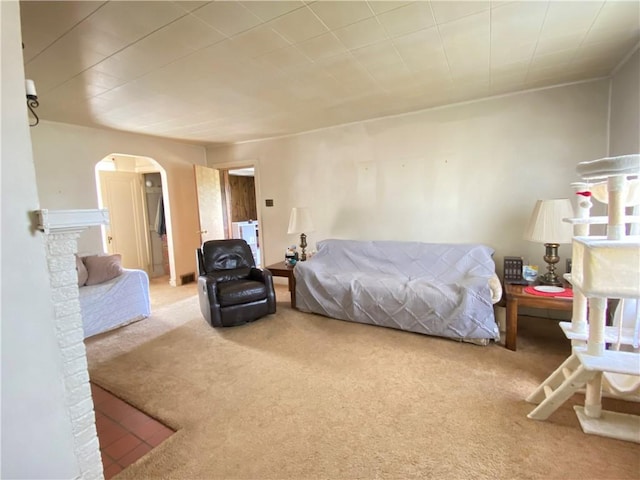 carpeted bedroom featuring arched walkways