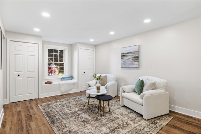 living area with wood finished floors, recessed lighting, and baseboards