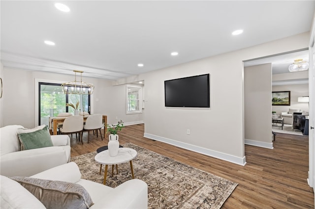 living area with wood finished floors, baseboards, a chandelier, and recessed lighting