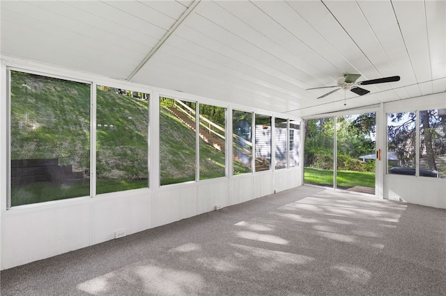 unfurnished sunroom featuring a ceiling fan