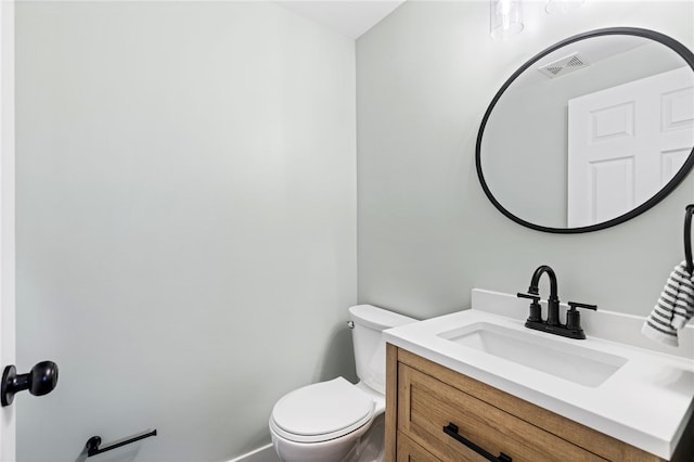 half bathroom with toilet and vanity