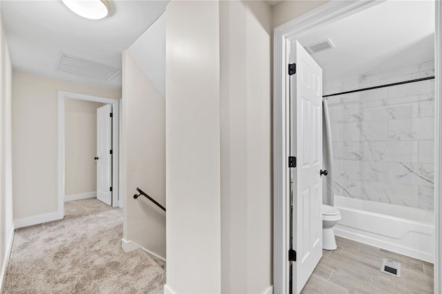 full bathroom with toilet, bathtub / shower combination, baseboards, and lofted ceiling