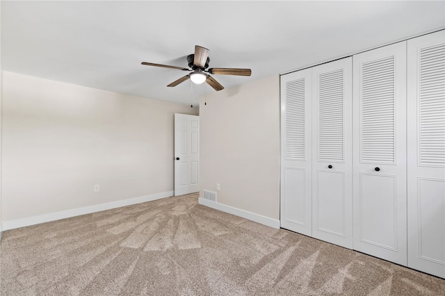 unfurnished bedroom featuring carpet floors, a closet, and baseboards