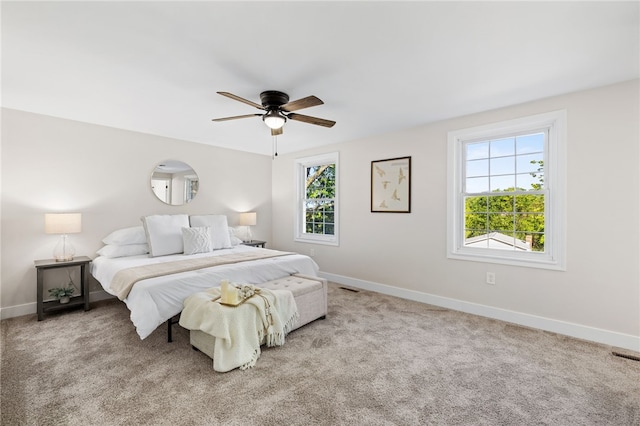 bedroom with baseboards, carpet, and a ceiling fan