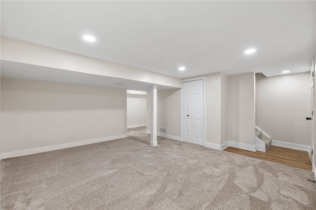 finished basement featuring carpet flooring, baseboards, recessed lighting, and stairway