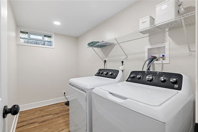 washroom featuring washer and dryer, wood finished floors, baseboards, and recessed lighting