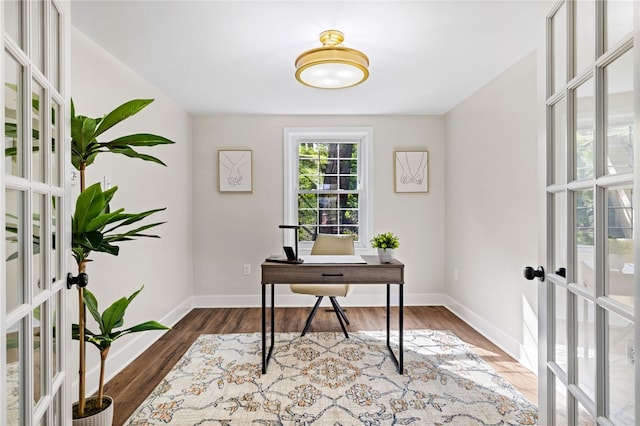 office space with french doors, baseboards, and wood finished floors