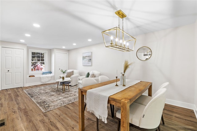 dining room featuring wood finished floors, baseboards, recessed lighting, and a chandelier