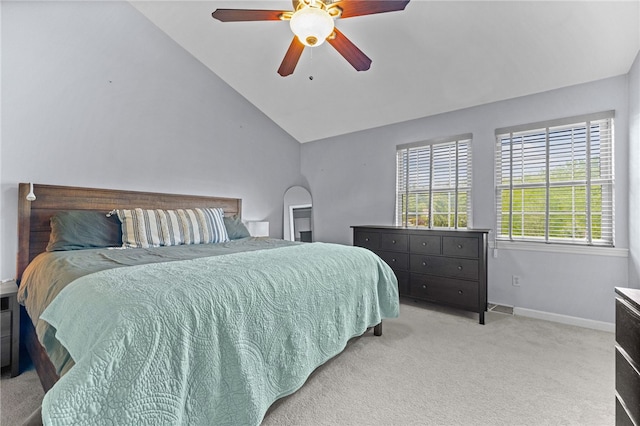carpeted bedroom featuring lofted ceiling, baseboards, and ceiling fan