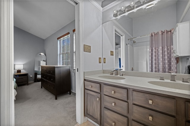 full bath with double vanity, a shower with curtain, and vaulted ceiling
