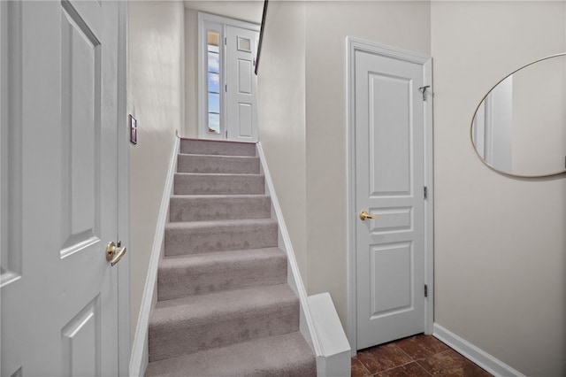 staircase featuring baseboards