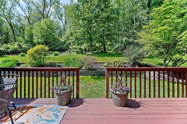 wooden terrace with a lawn