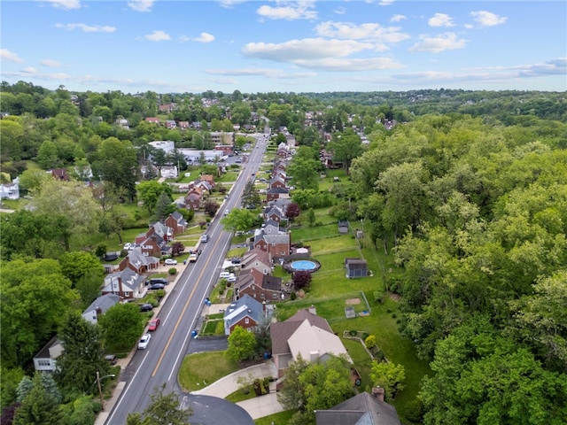 aerial view of property and surrounding area featuring nearby suburban area