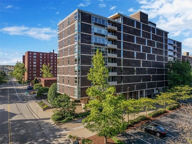 view of apartment building / complex with uncovered parking