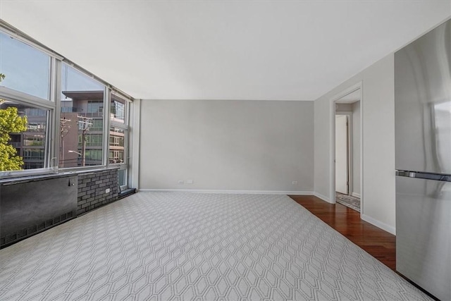 unfurnished room with baseboards