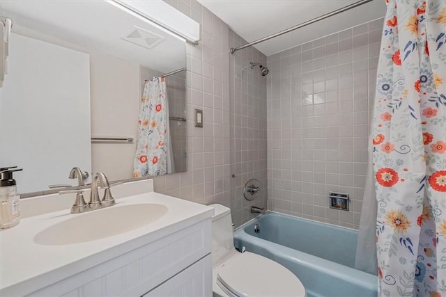 bathroom with shower / tub combo, toilet, and vanity