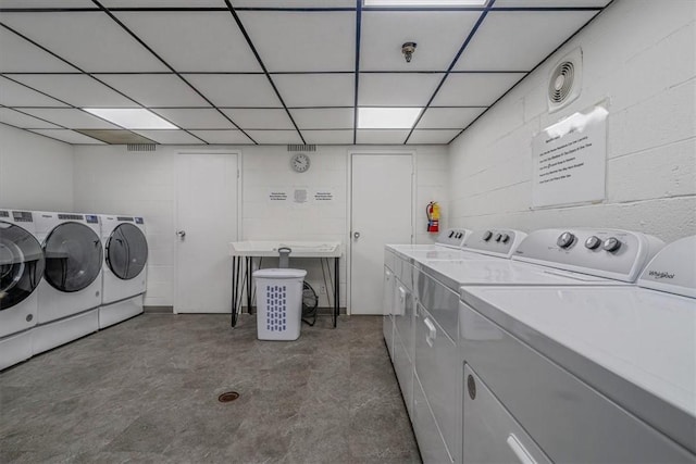 communal laundry room featuring washing machine and dryer
