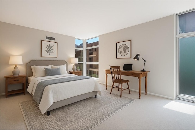 bedroom featuring light carpet, a desk, baseboards, and floor to ceiling windows