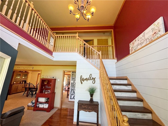 259 Old Mercer Rd, Springfield Twp Mer, PA 16156 - staircase featuring ornamental molding, a chandelier, a towering ceiling, wood finished floors, and baseboards