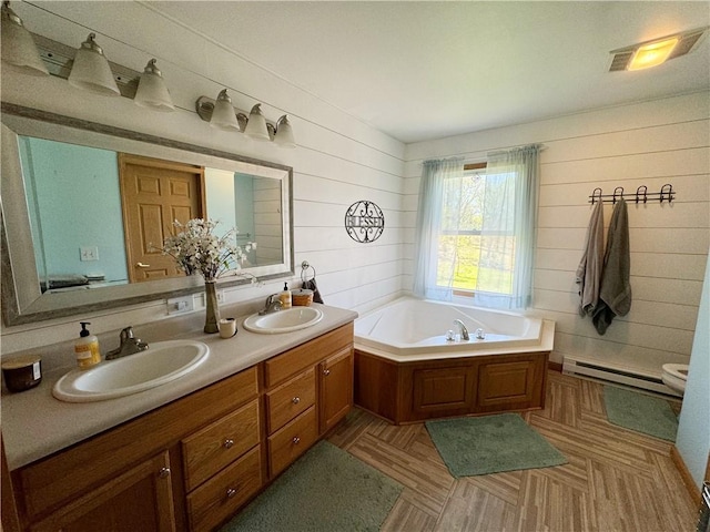 259 Old Mercer Rd, Springfield Twp Mer, PA 16156 - bathroom featuring a baseboard heating unit, wood walls, a garden tub, and double vanity