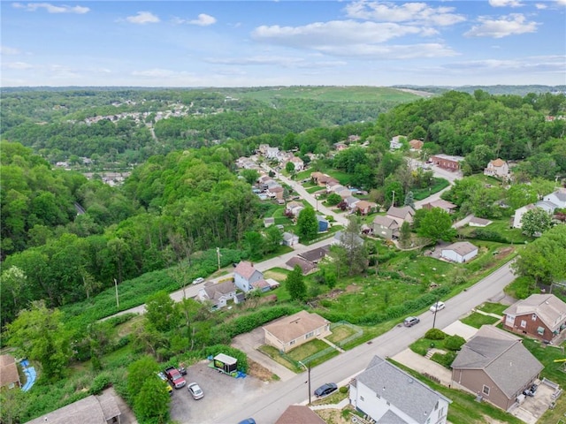 aerial view of residential area featuring a heavily wooded area