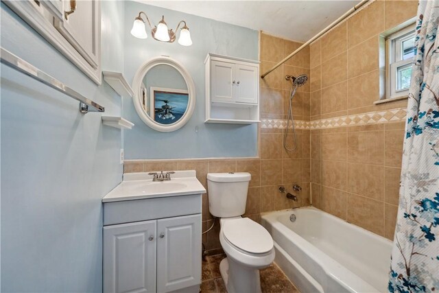 106 Boyanna Dr, Industry, PA 15052 - bathroom featuring tile walls, shower / tub combo, toilet, vanity, and wainscoting