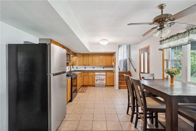 106 Boyanna Dr, Industry, PA 15052 - kitchen with appliances with stainless steel finishes, light tile patterned floors, and a ceiling fan