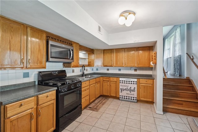 106 Boyanna Dr, Industry, PA 15052 - kitchen featuring stainless steel microwave, black gas range oven, a sink, decorative backsplash, and light tile patterned flooring