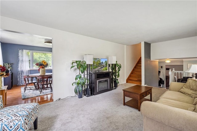 106 Boyanna Dr, Industry, PA 15052 - carpeted living area featuring stairs and a glass covered fireplace