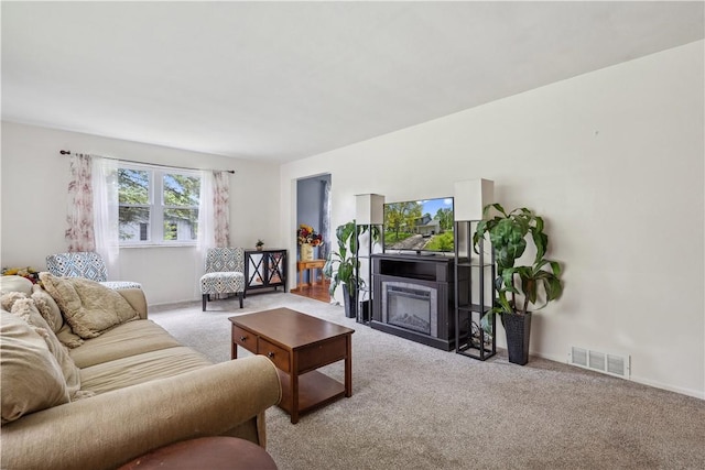 106 Boyanna Dr, Industry, PA 15052 - living area with light colored carpet, a glass covered fireplace, and baseboards