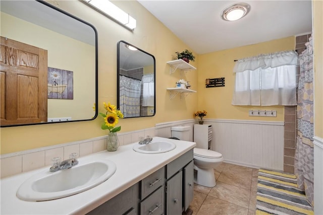106 Boyanna Dr, Industry, PA 15052 - full bath featuring a wainscoted wall, toilet, tile patterned flooring, and double vanity