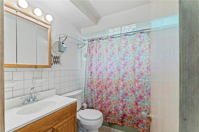 full bathroom with toilet, tile walls, and vanity