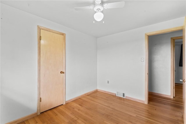 unfurnished bedroom with light wood-style floors, baseboards, and a ceiling fan