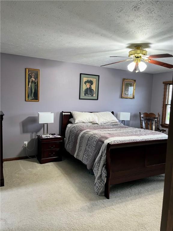 1016 Timberwood Ct, Murrysville, PA 15668 - bedroom with light carpet, a textured ceiling, and a ceiling fan