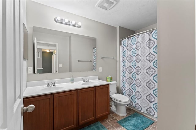 full bathroom with toilet, double vanity, a shower with shower curtain, a textured ceiling, and tile patterned floors
