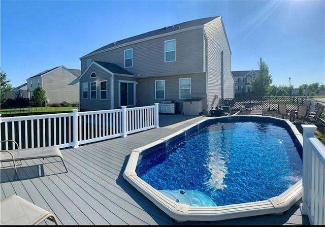 outdoor pool with a wooden deck