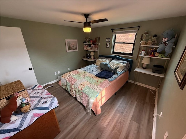 bedroom featuring wood finished floors, baseboards, and a ceiling fan