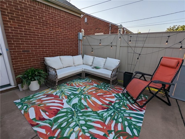 view of patio featuring outdoor lounge area and fence