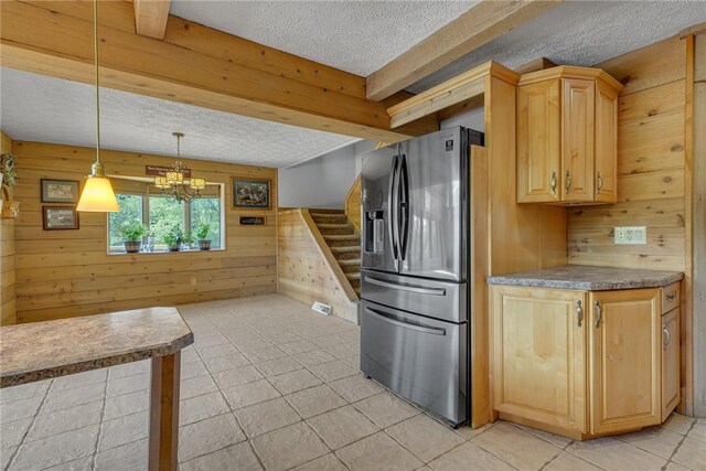584 Park Rd, Chippewa Twp, PA 15010 - kitchen featuring a textured ceiling, stainless steel fridge, wood walls, light brown cabinets, and light tile patterned floors