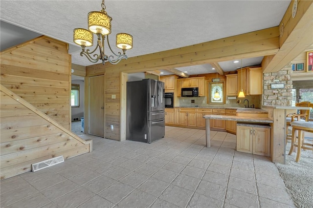 584 Park Rd, Chippewa Twp, PA 15010 - kitchen with black appliances, wooden walls, light countertops, a chandelier, and light tile patterned floors