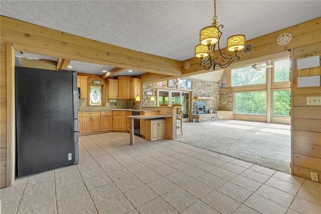 584 Park Rd, Chippewa Twp, PA 15010 - kitchen with freestanding refrigerator, light countertops, open floor plan, healthy amount of natural light, and a textured ceiling