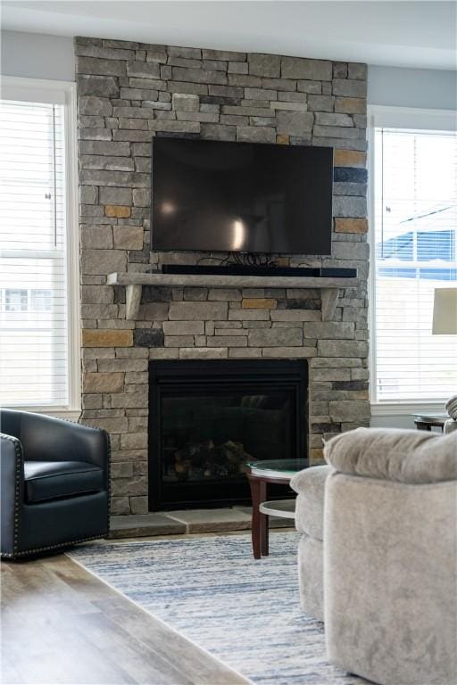 detailed view of a stone fireplace and wood finished floors