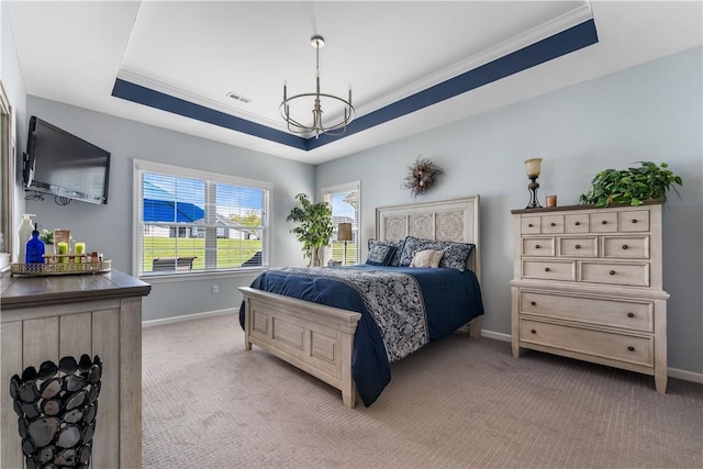 bedroom with a tray ceiling, a chandelier, baseboards, ornamental molding, and light carpet