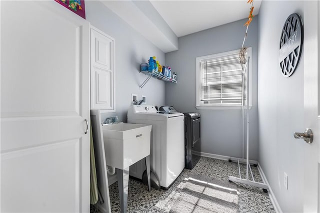 laundry area featuring washing machine and dryer and baseboards
